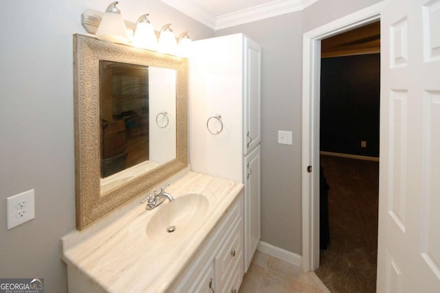 bathroom with baseboards, tile patterned flooring, and vanity
