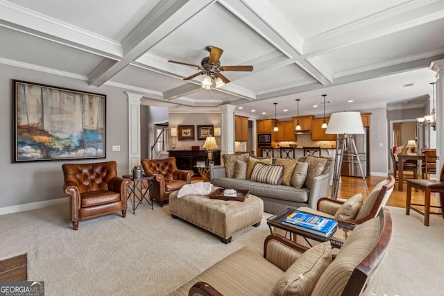 living area with baseboards, coffered ceiling, beamed ceiling, ornate columns, and ceiling fan with notable chandelier