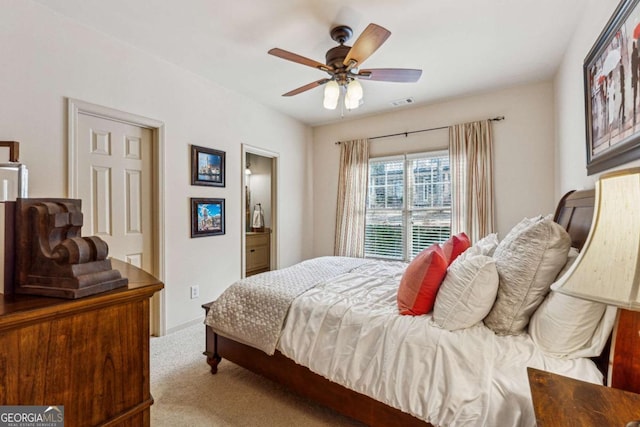 carpeted bedroom featuring a ceiling fan and visible vents