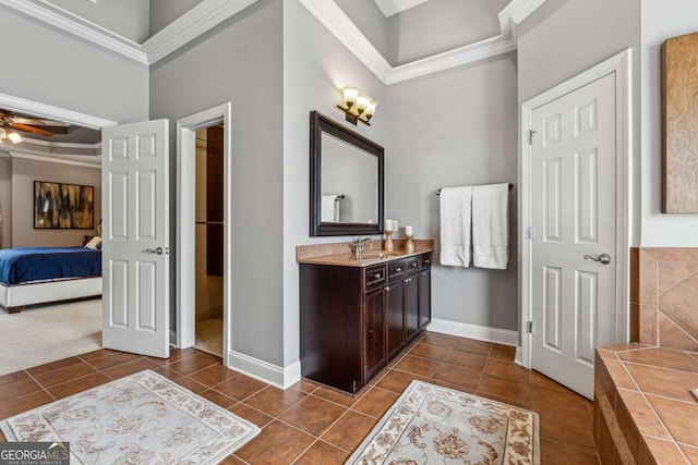 bathroom featuring ceiling fan, baseboards, and tile patterned floors