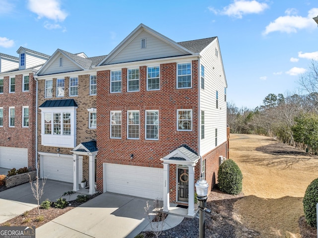 view of front of home with a garage, driveway, and brick siding