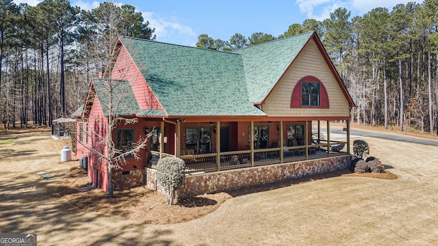 back of property with a porch, crawl space, roof with shingles, and driveway