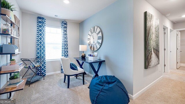 carpeted office with visible vents and baseboards