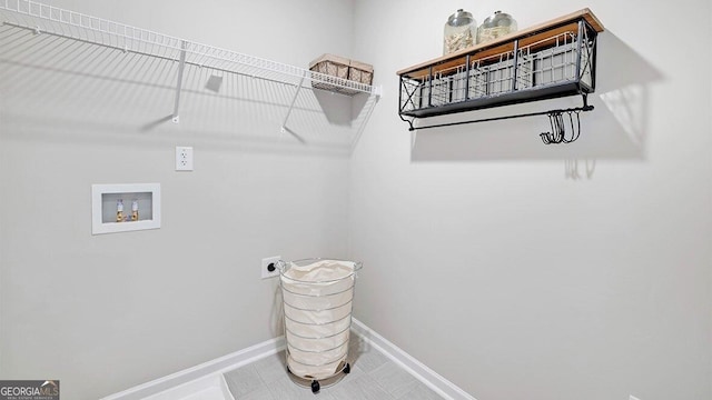 laundry area featuring laundry area, hookup for a washing machine, baseboards, and electric dryer hookup