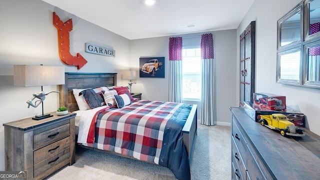 bedroom featuring visible vents, light carpet, and baseboards