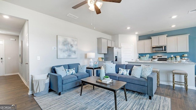 living room featuring recessed lighting, visible vents, dark wood finished floors, and baseboards