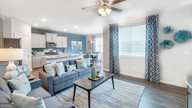 living area featuring ceiling fan, recessed lighting, dark wood-style flooring, visible vents, and baseboards