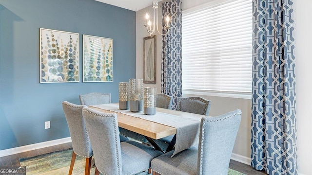 dining space with a wealth of natural light, baseboards, and wood finished floors