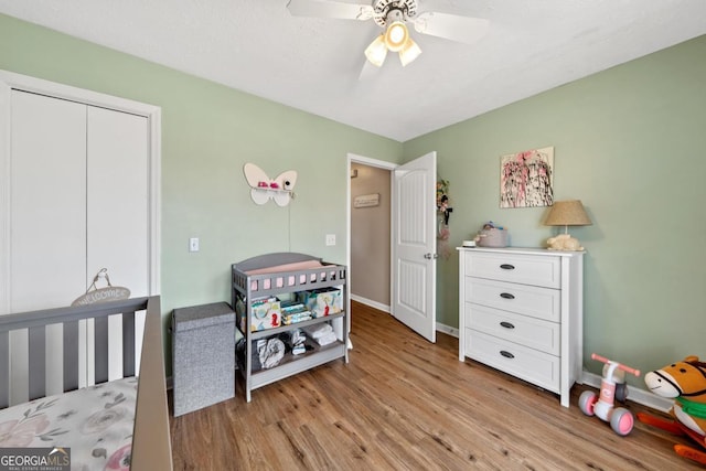 bedroom featuring ceiling fan, light wood-type flooring, and baseboards