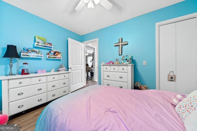 bedroom with a closet, ceiling fan, and wood finished floors