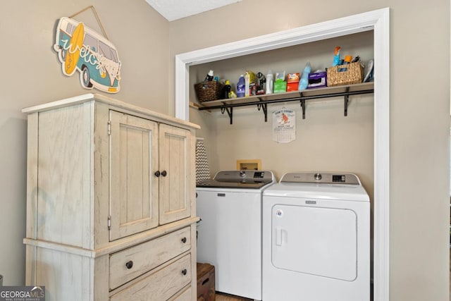 laundry area featuring independent washer and dryer and cabinet space