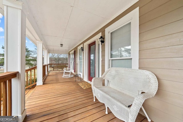 wooden terrace featuring covered porch