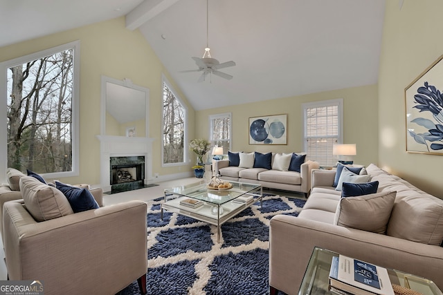 living area featuring a wealth of natural light, beamed ceiling, high vaulted ceiling, and a premium fireplace