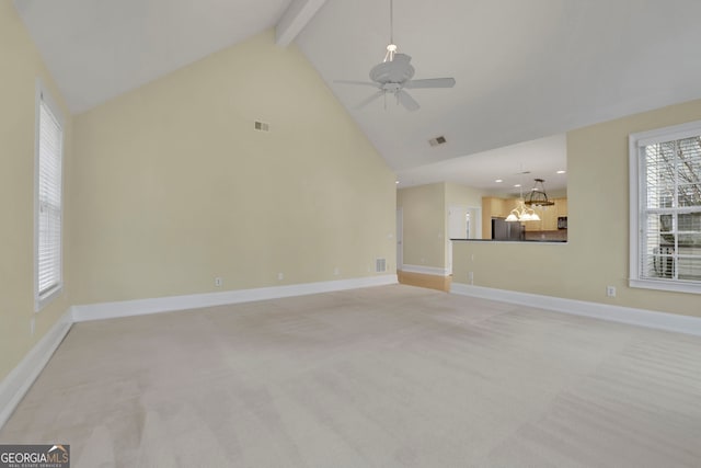 unfurnished living room with light carpet, beamed ceiling, visible vents, and baseboards