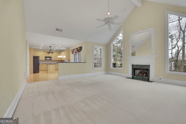 unfurnished living room featuring baseboards, visible vents, beam ceiling, a high end fireplace, and light carpet