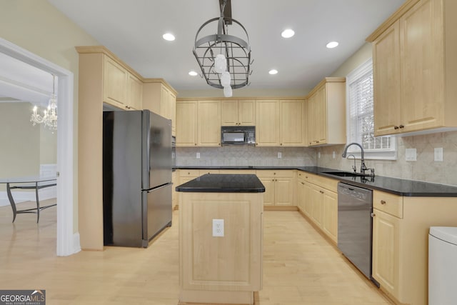 kitchen with dark countertops, light brown cabinets, black appliances, and a sink