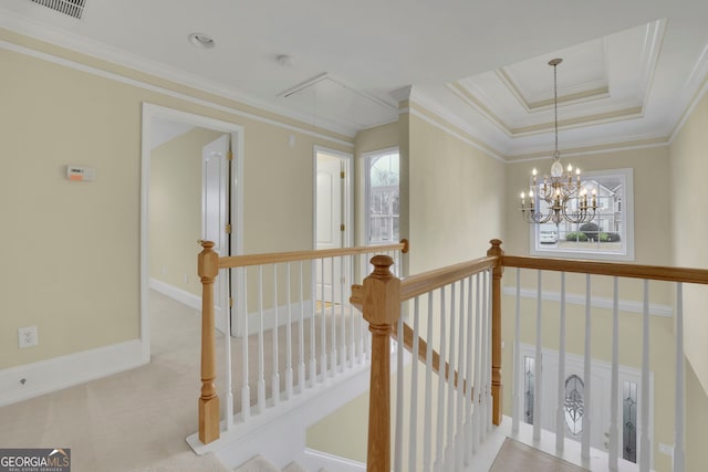 hall with an upstairs landing, carpet flooring, crown molding, baseboards, and attic access