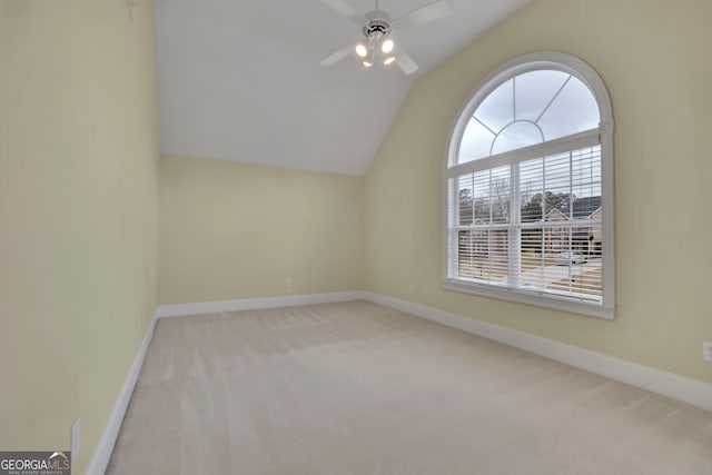 additional living space with baseboards, lofted ceiling, ceiling fan, and carpet flooring