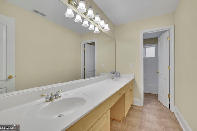 full bathroom featuring tile patterned flooring, visible vents, baseboards, double vanity, and a sink