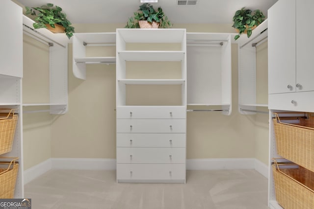 walk in closet featuring visible vents and carpet flooring