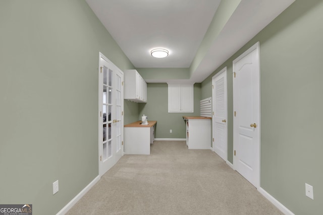 interior space with light colored carpet and baseboards