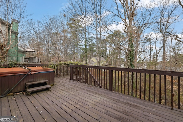 wooden deck with a hot tub