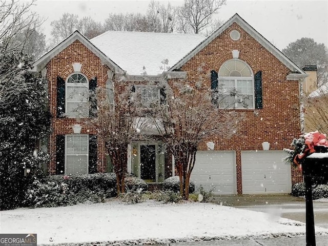 view of front of property with an attached garage and brick siding