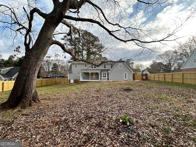 back of property featuring fence private yard