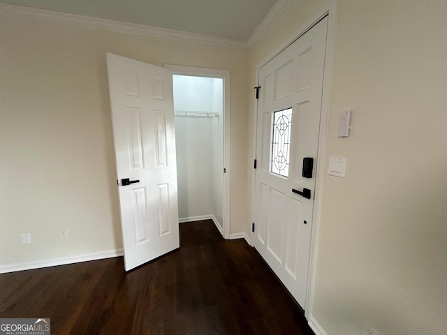 entryway with dark wood-style floors, ornamental molding, and baseboards