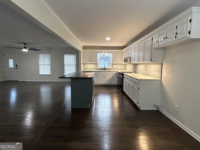 kitchen featuring stainless steel appliances, white cabinets, baseboards, and tasteful backsplash