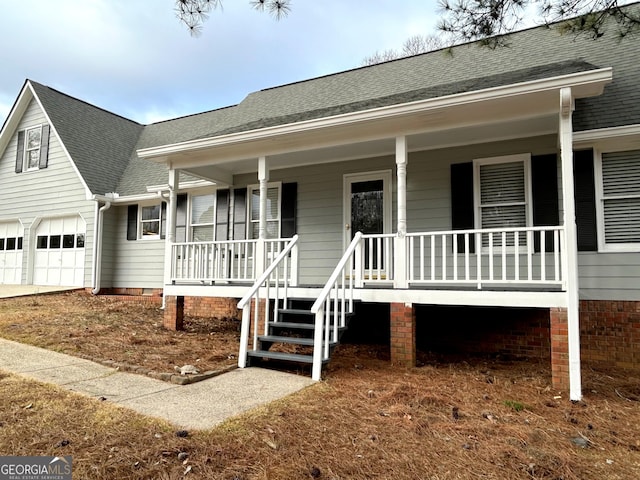 view of front of property with covered porch, crawl space, and roof with shingles