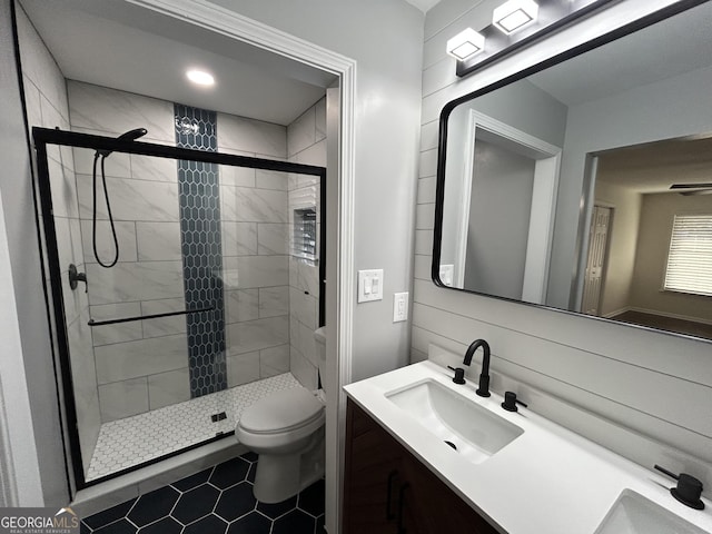 bathroom with vanity, a shower stall, and toilet