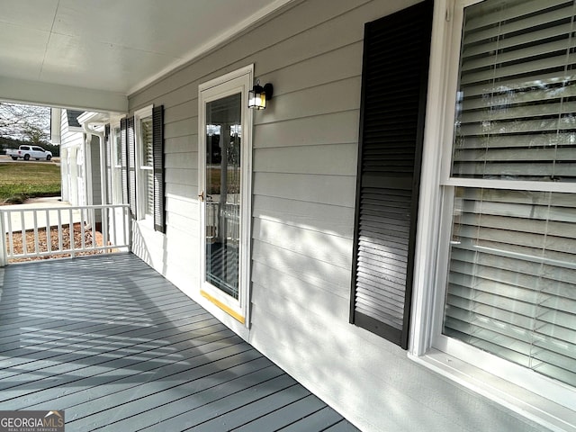 wooden terrace featuring covered porch