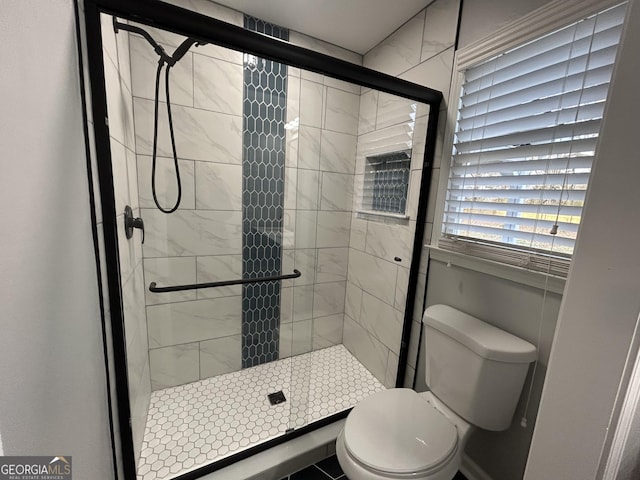 full bathroom featuring toilet and a shower stall