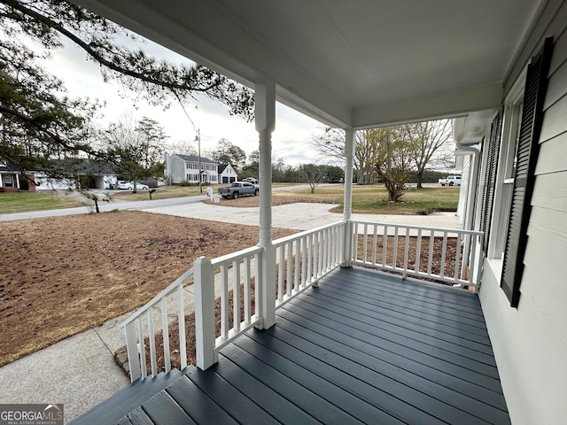 deck with covered porch and a residential view