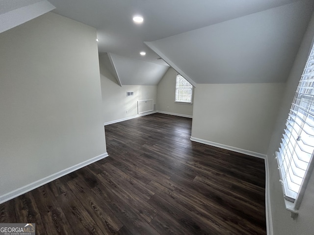 bonus room with recessed lighting, dark wood-type flooring, visible vents, baseboards, and vaulted ceiling