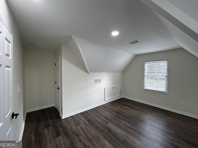 bonus room with dark wood-type flooring, visible vents, and baseboards