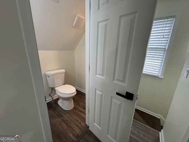 bathroom featuring baseboards, visible vents, toilet, and wood finished floors