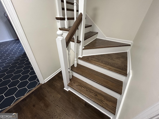 stairs featuring baseboards and wood finished floors