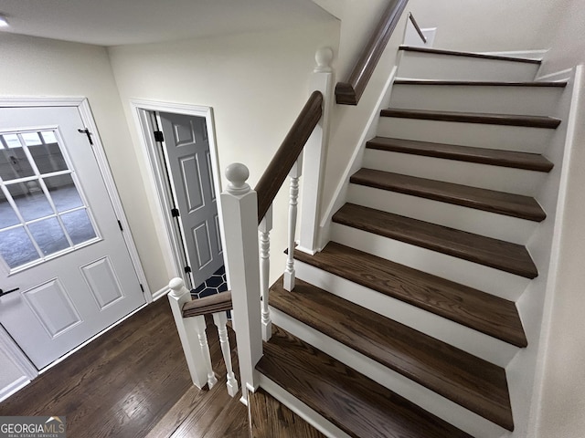 staircase with baseboards and wood finished floors