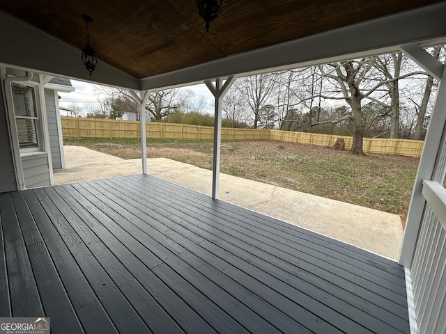 deck with a patio area and a fenced backyard