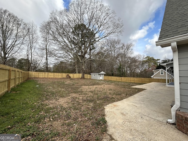 view of yard featuring a patio area, a fenced backyard, an outdoor structure, and a shed