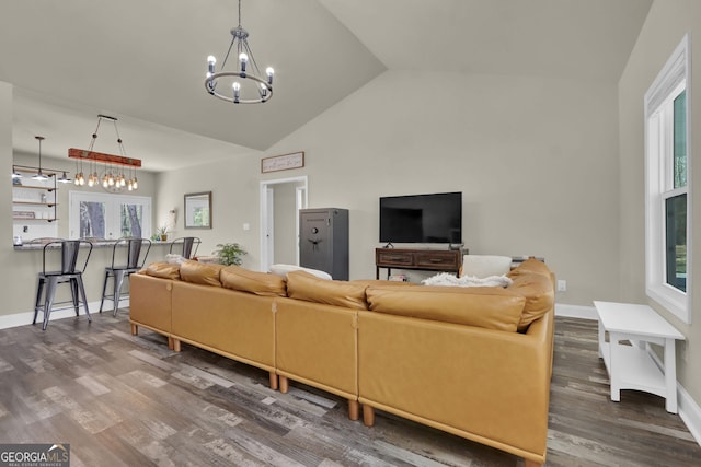 90 Jefferson Rd, Statham, GA 30666 - living area featuring baseboards, wood finished floors, high vaulted ceiling, and a notable chandelier