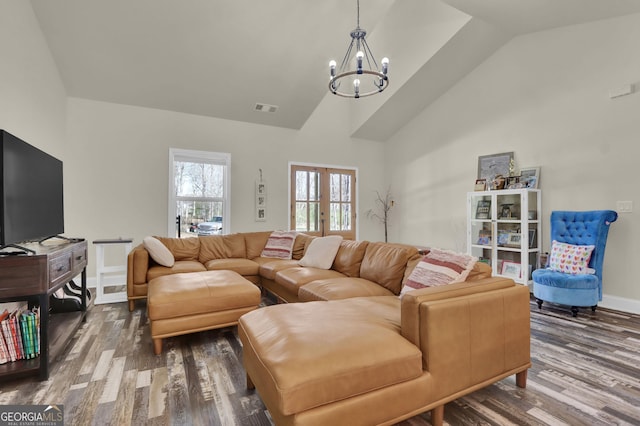 90 Jefferson Rd, Statham, GA 30666 - living area featuring high vaulted ceiling, an inviting chandelier, wood finished floors, and visible vents