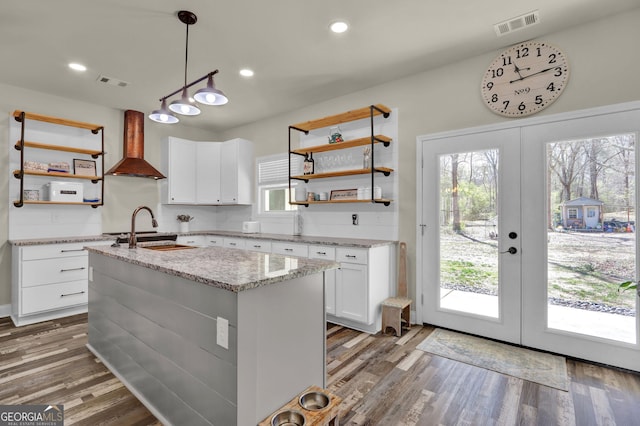 90 Jefferson Rd, Statham, GA 30666 - kitchen featuring wall chimney exhaust hood, open shelves, a sink, and visible vents