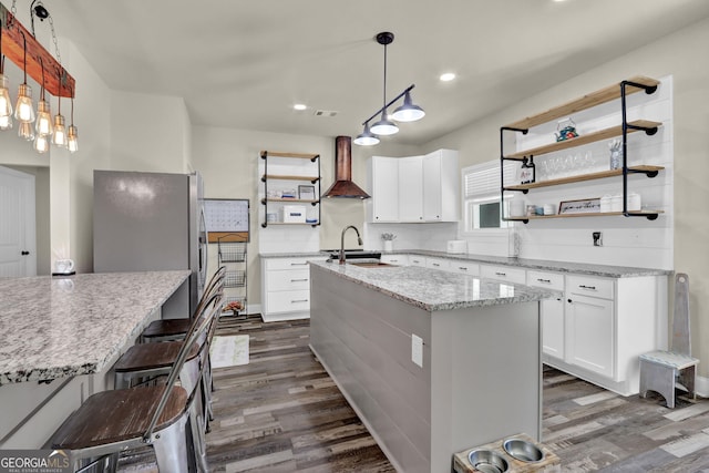 90 Jefferson Rd, Statham, GA 30666 - kitchen featuring dark wood-type flooring, an island with sink, wall chimney exhaust hood, and open shelves