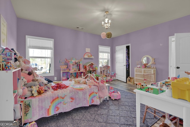 90 Jefferson Rd, Statham, GA 30666 - bedroom featuring wood finished floors, visible vents, an inviting chandelier, and multiple windows