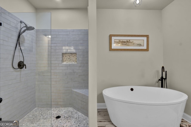 90 Jefferson Rd, Statham, GA 30666 - full bathroom featuring a freestanding bath, baseboards, and tiled shower