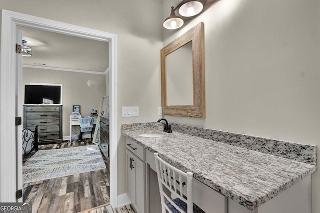 90 Jefferson Rd, Statham, GA 30666 - bathroom with baseboards, ornamental molding, vanity, and wood finished floors