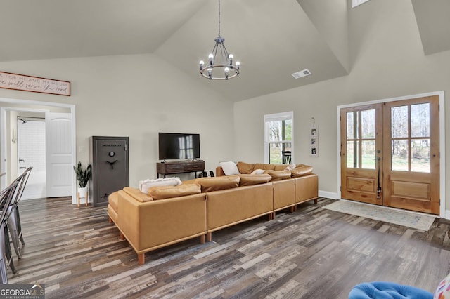 90 Jefferson Rd, Statham, GA 30666 - living area featuring wood finished floors, visible vents, french doors, a chandelier, and high vaulted ceiling